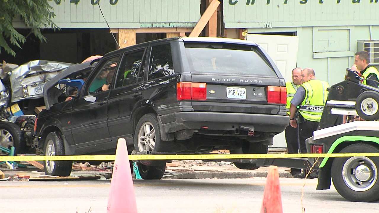 Three children were hurt after a Range Rover slammed into a parked car outside a Kansas City, Mo., day care on July 30, 2013. (WDAF-TV)