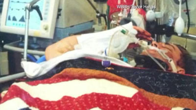 Corporal Josh Hargis was injured in Afghanistan. Lying in the hospital bed, he saluted when he was awarded a Purple Heart.